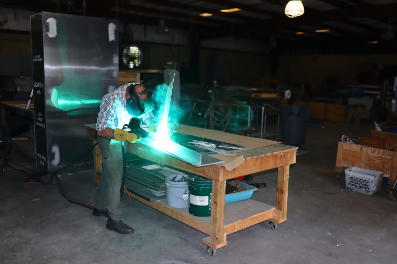 Master Craftsman Mark Dickson welding panel elements in the studio leading up to the installation